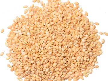 A pile of beige sesame seeds on a white background.