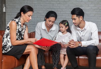 Parents receiving parent training and education from BCBS during in-home aba therapy treatment