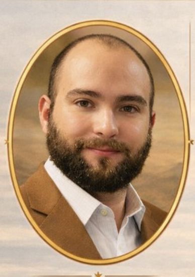 Portrait of a bearded man in brown jacket.