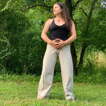 Woman teaching Qigong in nature 