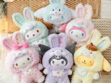 Cute plush toys dressed in pastel bunny costumes with various animal faces.