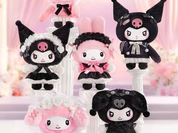 Cute plush dolls with gothic and pastel themes on display stands.
