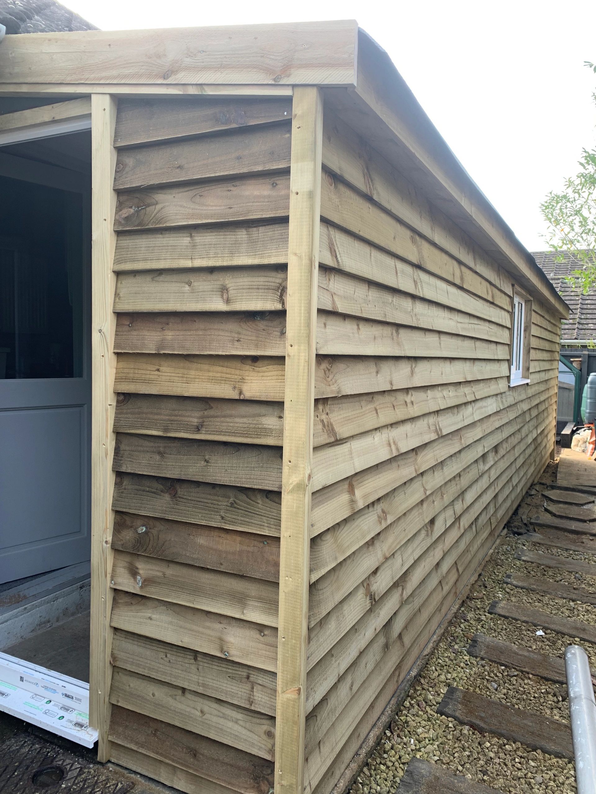 New wooden shed exterior with fresh timber cladding.
