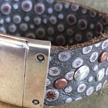 Exotic embossed leather cuff with rivets.