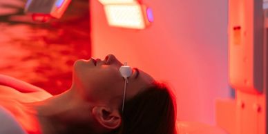 Woman undergoing a light therapy session with protective goggles.