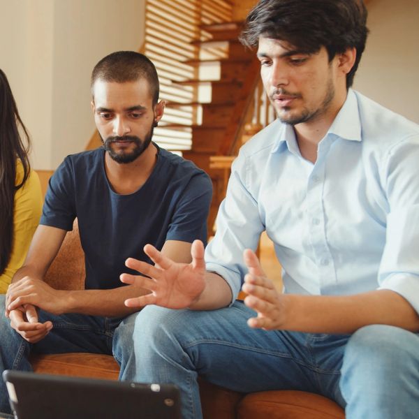 Group of four young adults engaged in a discussion.