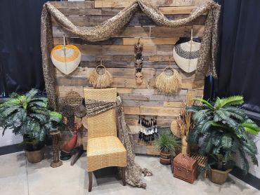 Rustic woven chair setup with tribal decorations.