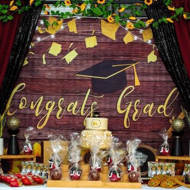 Graduation party table with cake and treats.