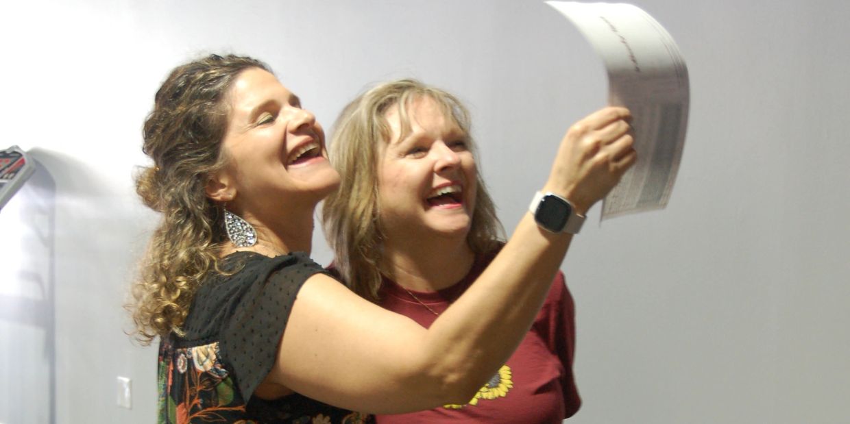 Nicole from Lighthouse Nutrition celebrates progress with a smiling client while reviewing InBody sc