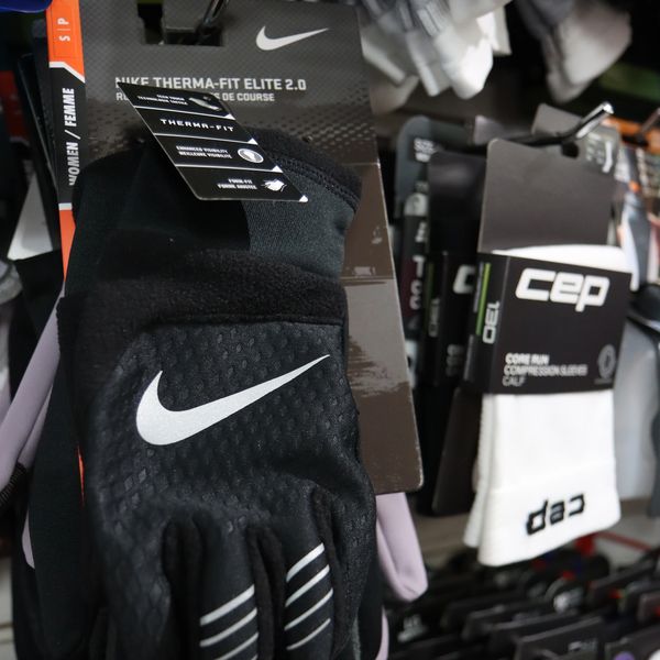 Black Nike Therma-Fit Elite 2.0 gloves on display in a store.