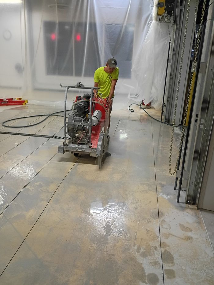 Walk-behind saw cutting an indoor concrete floor