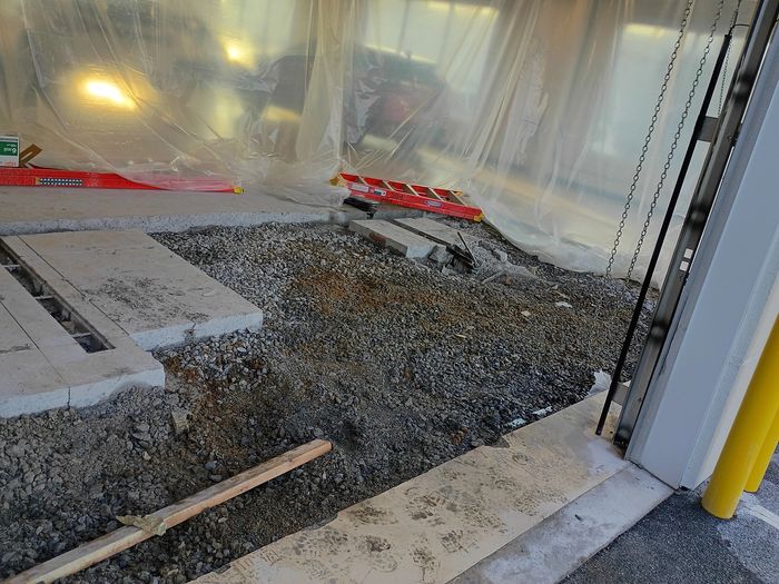 Cut-out section of floor with gravel base and forms
