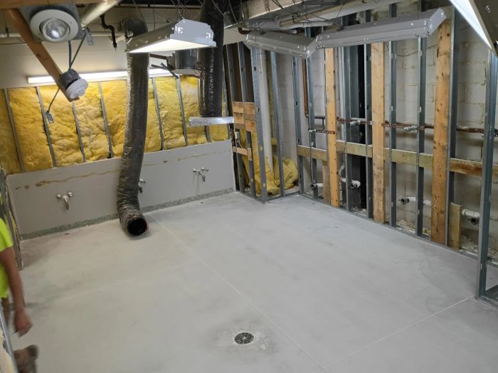 Framed interior under construction with the concrete floor ground clean
