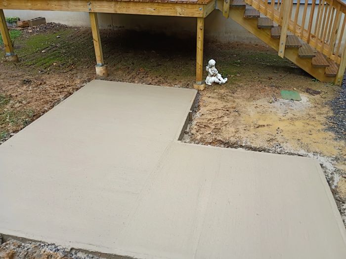 Poured concrete pad beside a deck