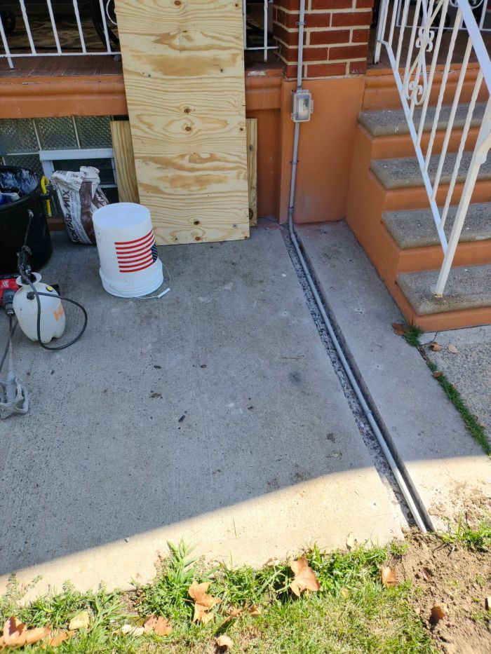 Joint in a concrete slab beside porch steps, cleaned out