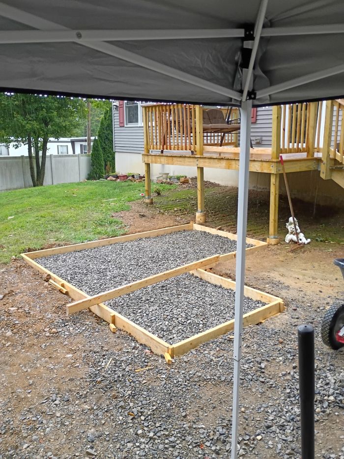 Wooden forms filled with gravel, ready for a pour
