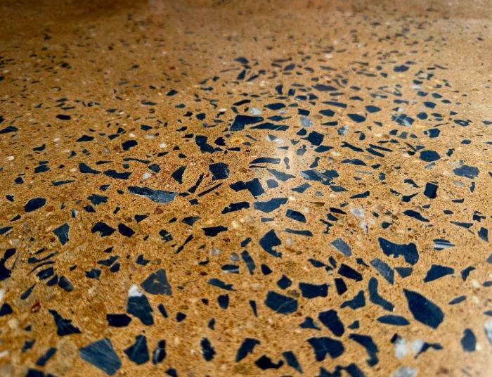 Close view of a glossy tan floor with dark chips