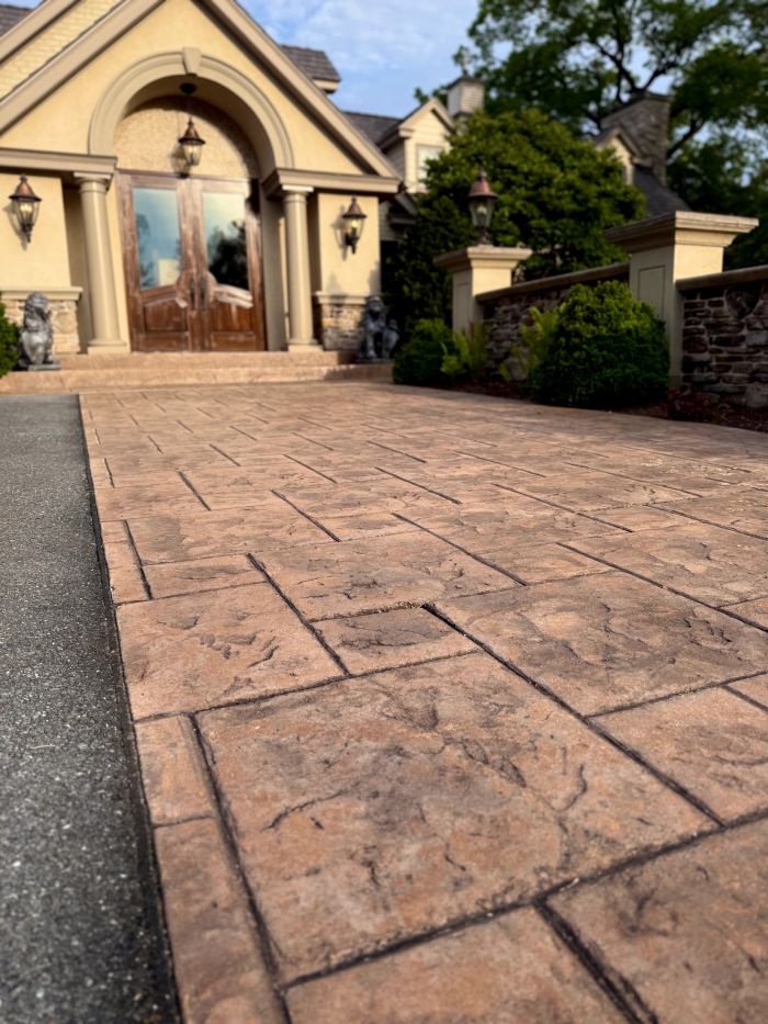 Stamped concrete walk leading to the front entrance of a house