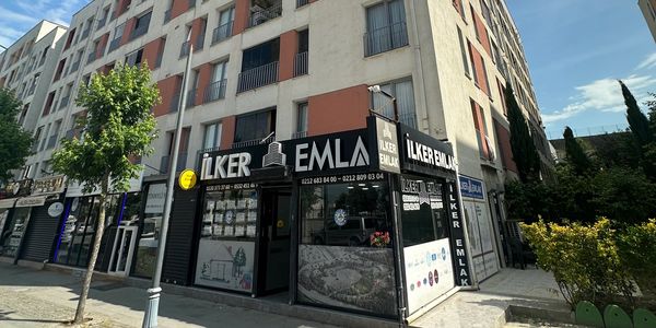 Corner real estate office with black signage on a residential building.