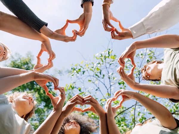People forming hearts with hands.

