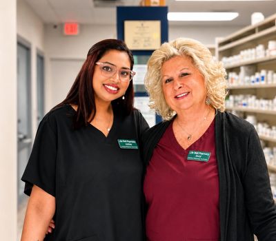 Two pharmacist at the Johnson City Life Well pharmacy location.