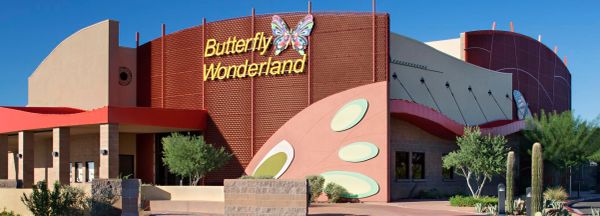 Butterfly Wonderland building exterior under clear blue sky.
