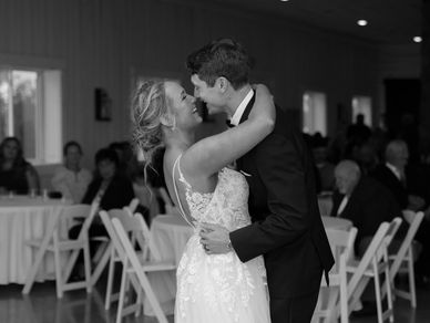 Bride and groom share a kiss during their wedding dance.