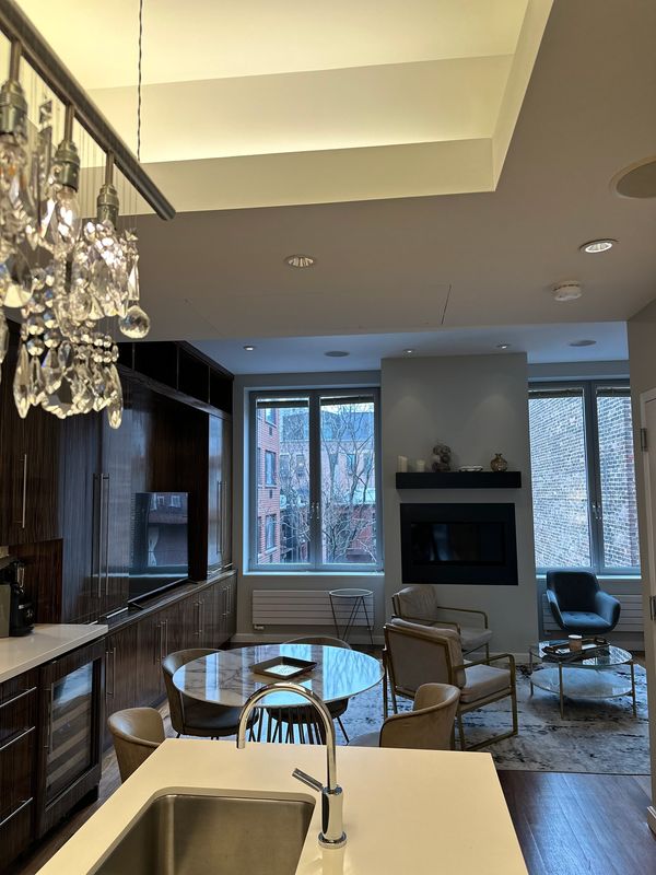 living space in penthouse with three chairs and marble table 