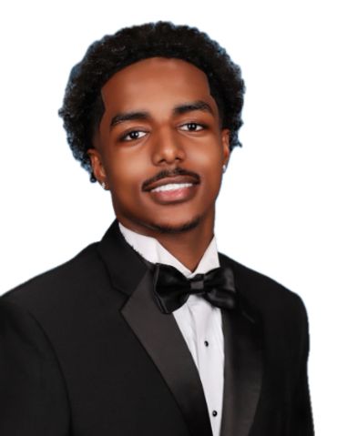 Young man in tuxedo with bow tie smiling.