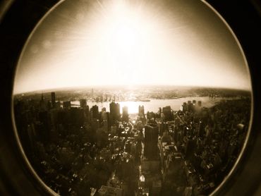 Fisheye view of a city skyline at sunset.