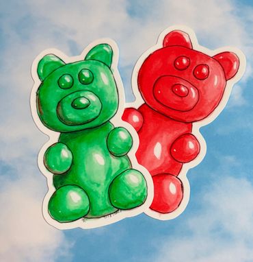 Red and green gummy bear stickers on a sky background 