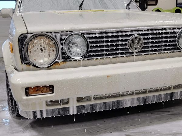 White Volkswagen car front with icicles hanging from the bumper.