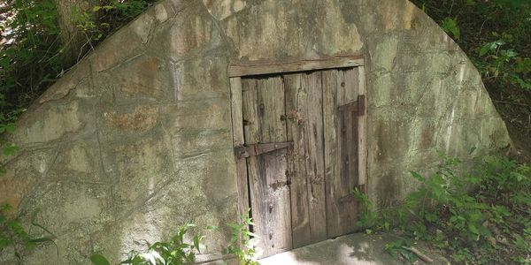 small door in an arched stone wall