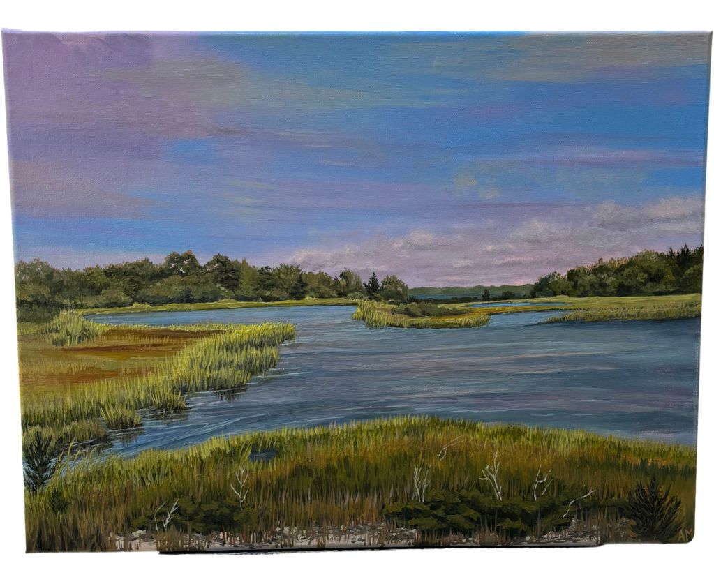 A peaceful river landscape with lush green marshes under a soft blue sky.