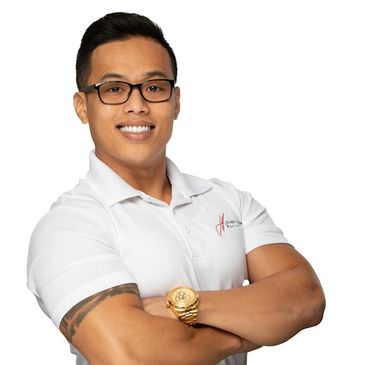 Confident man with glasses and tattoo, wearing a white polo shirt.