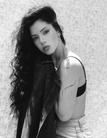 Black and white portrait of a woman with wavy hair.