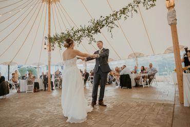 First dance in tented outdoor wedding reception
