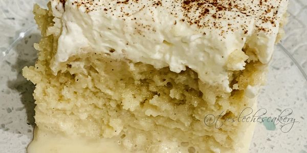 a close up of a slice of traditional tres leches cake on a clear plate