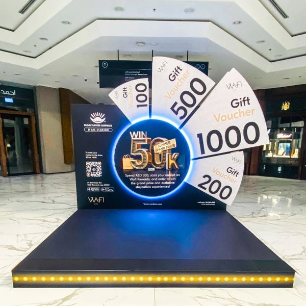 Promotional display for Dubai Summer Surprises with gift vouchers and a grand prize.