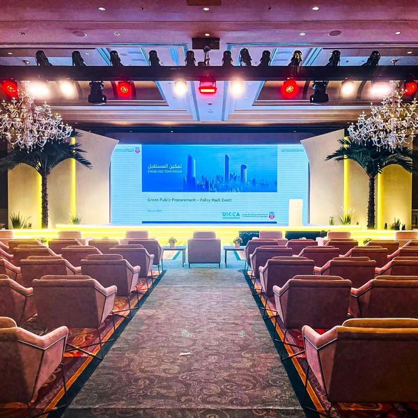 Elegant conference room set for a Green Public Procurement policy event.