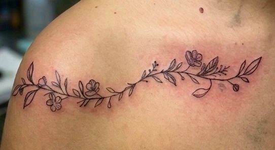 Custom floral vine collarbone tattoo done by artist Laura Bailey.