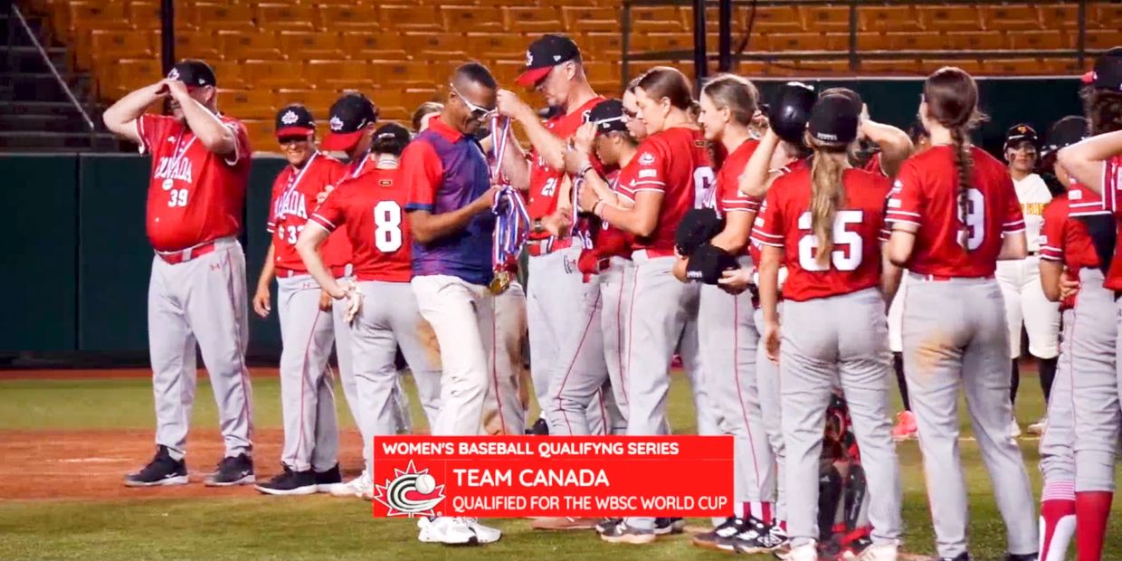 Team Canada women's baseball players receiving medals after qualifying for the WBSC World Cup.