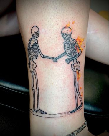 Tattoo of two human skeleton, one of them on fire