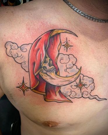 Tattoo of a crescent moon skull with red veil