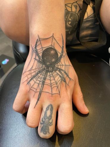 Tattoo of spider on hand