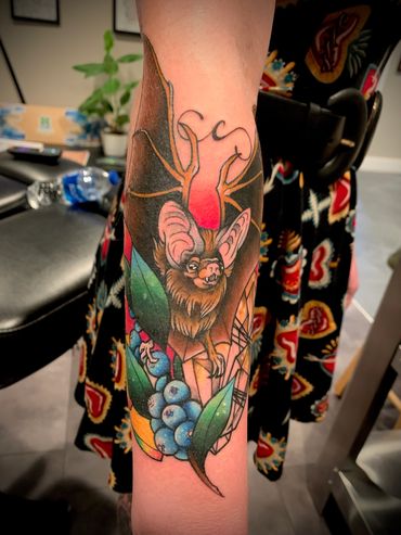Colorful tattoo of a fruit bat