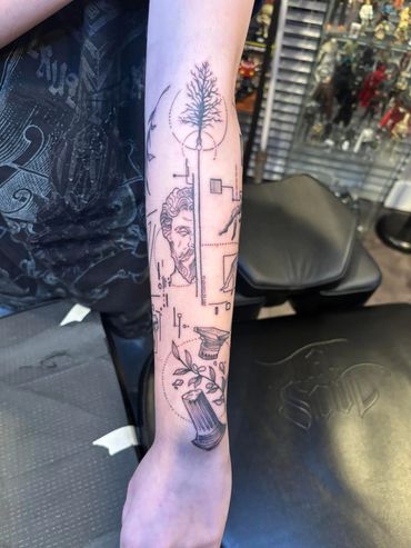 Tattoo of a man’s head and a pillar