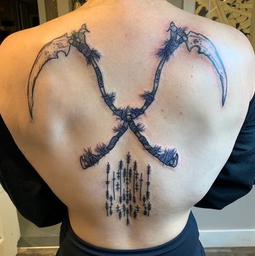 Crossing sickle tattoo on back