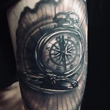 Black and white open compass tattoo