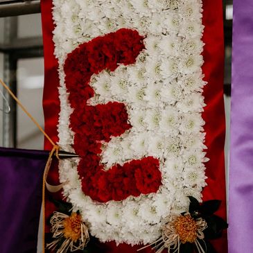 Floral banner with letter E